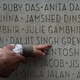 An Indo-Canadian woman shows her two-year-old grandson where the name of her husband and his grandfather, Daljit Singh Grewal, is located on a monument during a memorial marking the 25th anniversary of the Air India bombing in Vancouver, B.C., in June 2010.